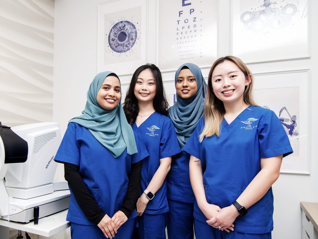 Four members of The Straits Eye Centre&rsquo;s clinic team, in Straits scrubs in a clinic room.
