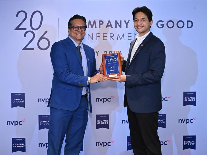 Dr Jayant V Iyer and a presenter holding a Company of Good 2026 to 2028 plaque in front of an NVPC backdrop.