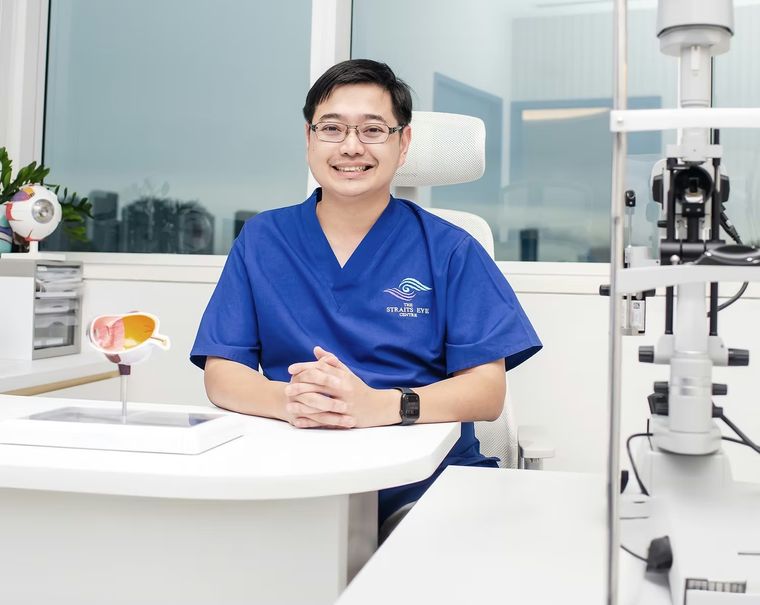 Dr Jason Lee seated at a consultation desk in the clinic.