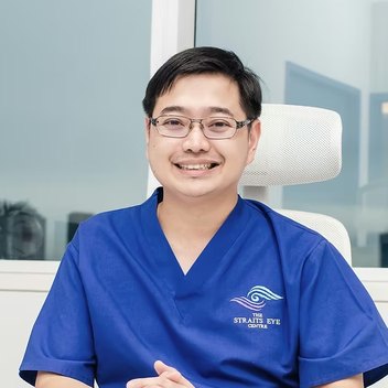 Dr Jason Lee seated at a consultation desk in the clinic.