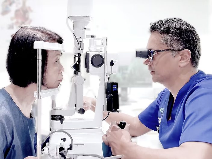Dr Jayant V Iyer examining a patient&rsquo;s eye at a slit lamp.