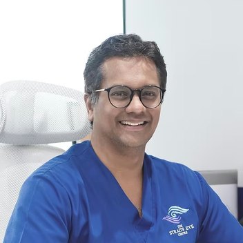 Dr Jayant V Iyer seated at a consultation desk in the clinic.