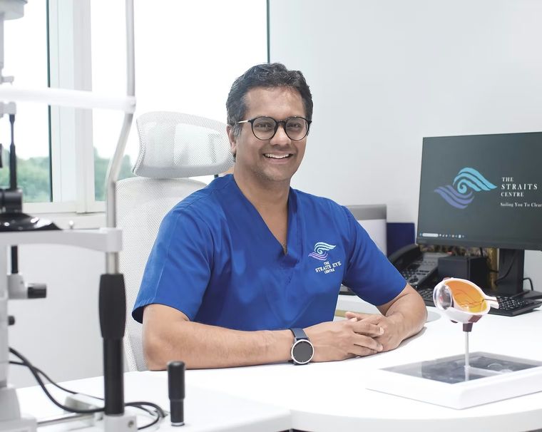 Dr Jayant V Iyer seated at a consultation desk in the clinic.