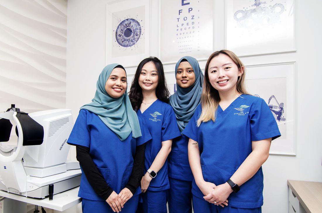 Four members of The Straits Eye Centre&rsquo;s clinic team, in Straits scrubs in a clinic room.